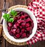 A bowl of beets and a fork

Description automatically generated