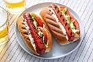 A plate of hot dogs

Description automatically generated