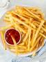 A plate of french fries with ketchup

Description automatically generated